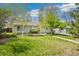 Well-manicured front yard of this single-story home featuring mature trees at 3485 S Forest St, Denver, CO 80222