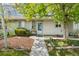 Cozy front porch with a chair and well-kept garden beds, offering a welcoming entrance to the home at 3485 S Forest St, Denver, CO 80222