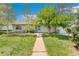 Charming single-story home features a well-maintained lawn, mature trees, and a welcoming walkway to the front door at 3485 S Forest St, Denver, CO 80222