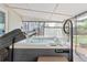 Hot tub with an open lid and comfortable seating on a covered porch at 3485 S Forest St, Denver, CO 80222