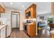 Kitchen view featuring wood cabinetry, modern appliances, and convenient access to the adjacent dining and living spaces at 3485 S Forest St, Denver, CO 80222