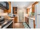 Functional kitchen featuring wood cabinets, modern appliances, and seamless access to the in-unit laundry area at 3485 S Forest St, Denver, CO 80222