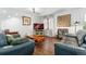 Cozy living room with hardwood floors, comfortable seating, and a decorative fireplace at 3485 S Forest St, Denver, CO 80222