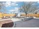 Expansive backyard features manicured landscaping, a seating area, and a storage shed at 214 N 10Th Ave, Brighton, CO 80601