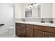 Spacious bathroom features double sinks, wood cabinetry, modern lighting, and sleek countertops at 214 N 10Th Ave, Brighton, CO 80601