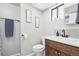 Updated bathroom features wooden vanity, white countertops, modern fixtures and decorative wall art at 214 N 10Th Ave, Brighton, CO 80601