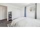 Serene bedroom with a comfortable bed, built-in bookcase, and soft blue curtains offering a relaxing ambiance at 214 N 10Th Ave, Brighton, CO 80601