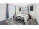 Well-lit bedroom with a patterned rug, comfortable bed, and matching nightstands creating a restful retreat at 214 N 10Th Ave, Brighton, CO 80601