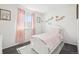 Charming bedroom features white furniture, plush carpet, and lovely decor at 214 N 10Th Ave, Brighton, CO 80601