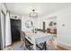 Bright dining room featuring a chandelier, hardwood floors, and seamless flow to the kitchen at 214 N 10Th Ave, Brighton, CO 80601