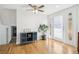 Bright entryway featuring hardwood floors, a decorative cabinet, and a glass-paneled door leading outside at 214 N 10Th Ave, Brighton, CO 80601