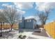 Private fenced-in backyard with mature trees, patio, and tidy landscaping at 214 N 10Th Ave, Brighton, CO 80601