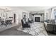 Bright living room with gray brick fireplace, plush rug, and modern decor accents at 214 N 10Th Ave, Brighton, CO 80601