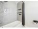 Updated shower with white subway tile, modern fixtures, and built-in shelving providing a clean and stylish space at 214 N 10Th Ave, Brighton, CO 80601