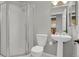Cozy bathroom featuring a shower stall and pedestal sink at 1780 N Washington St # 405, Denver, CO 80203