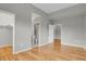 Open bedroom featuring hardwood floors, an ensuite bathroom, and closet at 1780 N Washington St # 405, Denver, CO 80203