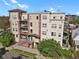A beautiful multi-story condo building with a brick facade and landscaped grounds under a sunny sky at 1780 N Washington St # 405, Denver, CO 80203