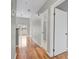 Hallway with wood floors and white trim, leading to bright rooms and a balcony, offering open flow at 1780 N Washington St # 405, Denver, CO 80203