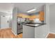 A stylish kitchen featuring stainless steel appliances and a breakfast bar, blending functionality with modern design at 1780 N Washington St # 405, Denver, CO 80203