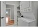 Laundry room featuring a stacked washer and dryer unit, with access to the bedroom at 1780 N Washington St # 405, Denver, CO 80203