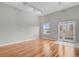 Bright living room with hardwood floors, neutral walls, and a door to a balcony for outdoor enjoyment at 1780 N Washington St # 405, Denver, CO 80203