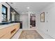 Bathroom with double vanity, glass shower, and a walk-in closet at 501 Lois Dr, Louisville, CO 80027