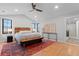Bedroom with wood floors, vaulted ceiling, and an adjacent bathroom with a glass shower at 501 Lois Dr, Louisville, CO 80027