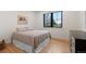 Bright bedroom with hardwood floors, a large window, and a comfortable queen-sized bed at 501 Lois Dr, Louisville, CO 80027