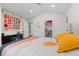 Bright bedroom with vaulted ceiling, walk-in closet, and colorful decor at 501 Lois Dr, Louisville, CO 80027