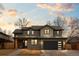 Charming two-story home showcasing neutral siding, a black garage door, and a cozy covered porch at 501 Lois Dr, Louisville, CO 80027