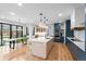 Well-lit open kitchen with a spacious island, stainless appliances, and modern dining table at 501 Lois Dr, Louisville, CO 80027