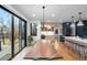 Contemporary kitchen features stainless appliances, an island with seating, and hardwood floors at 501 Lois Dr, Louisville, CO 80027