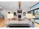 Spacious living room with hardwood floors, fireplace, and open layout to dining at 501 Lois Dr, Louisville, CO 80027