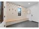 Welcoming mudroom featuring custom bench seating and stylish wallpaper at 501 Lois Dr, Louisville, CO 80027