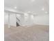 Spacious carpeted basement with a staircase and multiple doorways at 8230 Snake River St, Littleton, CO 80125