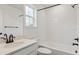 Bright bathroom features a tiled shower, modern fixtures, and a white vanity at 8230 Snake River St, Littleton, CO 80125