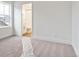 Sunlit bedroom showing neutral carpet and a view of attached bathroom at 8230 Snake River St, Littleton, CO 80125