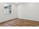Cozy bedroom showcasing hardwood floors, white walls, and a window allowing natural light at 8230 Snake River St, Littleton, CO 80125