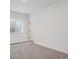 Bedroom featuring neutral carpet, and a view of door and window with grate at 8230 Snake River St, Littleton, CO 80125