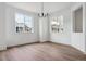 Bright dining area featuring hardwood floors, a modern chandelier, and windows at 8230 Snake River St, Littleton, CO 80125