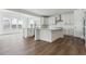 Open-concept kitchen with white cabinets, stainless steel appliances, and eat-in island at 8230 Snake River St, Littleton, CO 80125