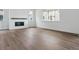 Bright living room featuring a modern fireplace and beautiful hardwood floors at 8230 Snake River St, Littleton, CO 80125