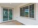 Covered patio with sliding glass door and a large window at 8230 Snake River St, Littleton, CO 80125