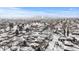 Expansive aerial view of a snow-covered neighborhood with the city skyline in the distance at 4518 Vallejo St, Denver, CO 80211