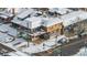 Aerial view of a commercial building with a second story outdoor patio covered in snow at 4518 Vallejo St, Denver, CO 80211