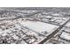 Winter aerial view of residential area featuring snow covered roofs and a commercial center nearby at 4518 Vallejo St, Denver, CO 80211