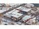 Birds eye view of commercial buildings with rooftop HVAC systems covered in snow in a winter landscape at 4518 Vallejo St, Denver, CO 80211