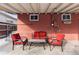 Cozy back patio with red outdoor furniture, perfect for relaxing and entertaining at 4518 Vallejo St, Denver, CO 80211