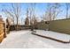 Snowy backyard with a storage shed and wooden fence at 4518 Vallejo St, Denver, CO 80211