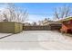 View of the spacious backyard with snow-covered ground and a storage shed at 4518 Vallejo St, Denver, CO 80211